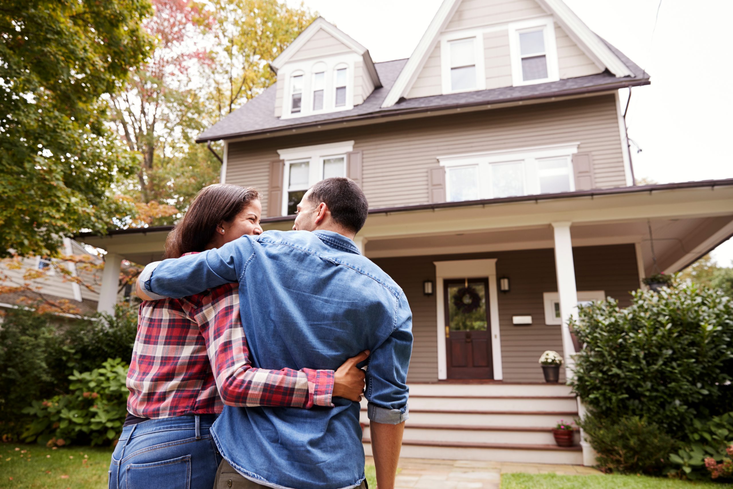 Couple walking towards new home together